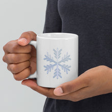 Load image into Gallery viewer, Hands holding a white coffee mug with a snowflake design
